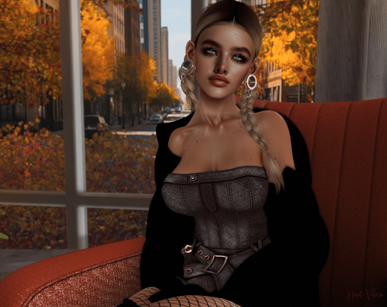 Image a female avatar with dark blonde braids sitting on an orange chair wearing a dark denim dress.